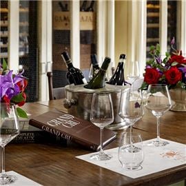 Dinner table with wine tasting placemats and cups